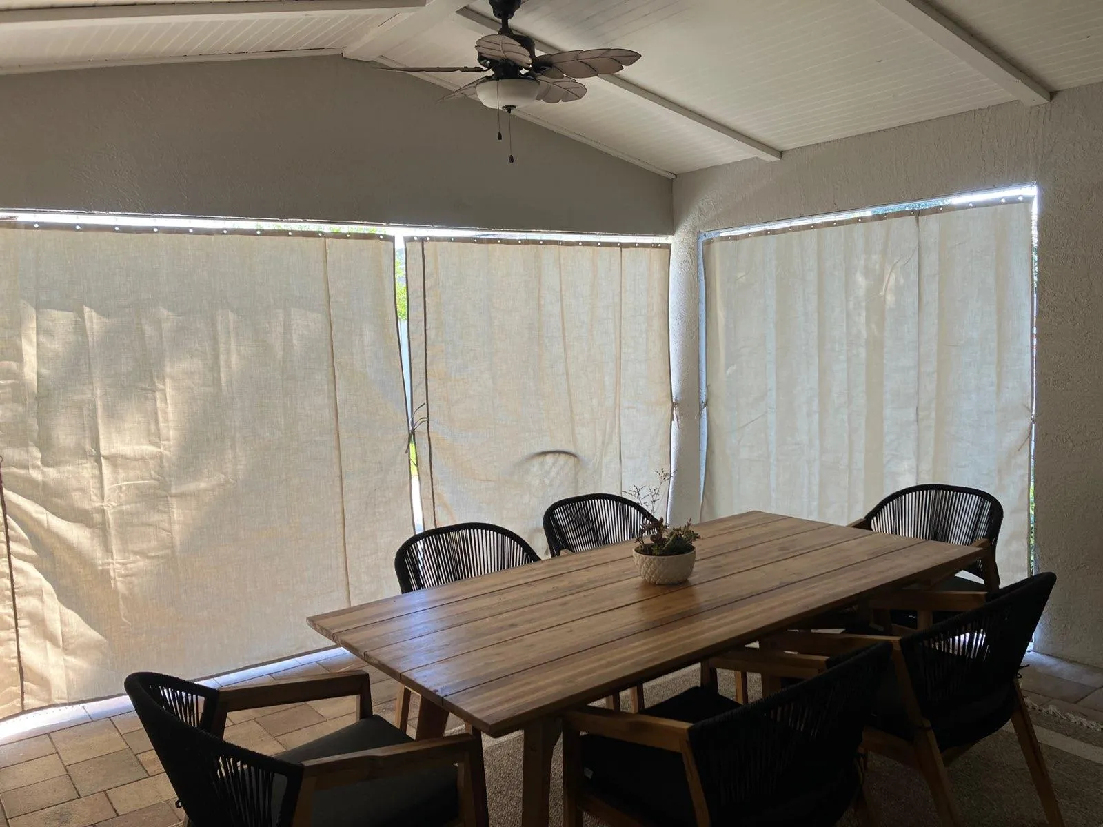 Cream outdoor curtains creating intimate dining space in Punta Gorda lanai