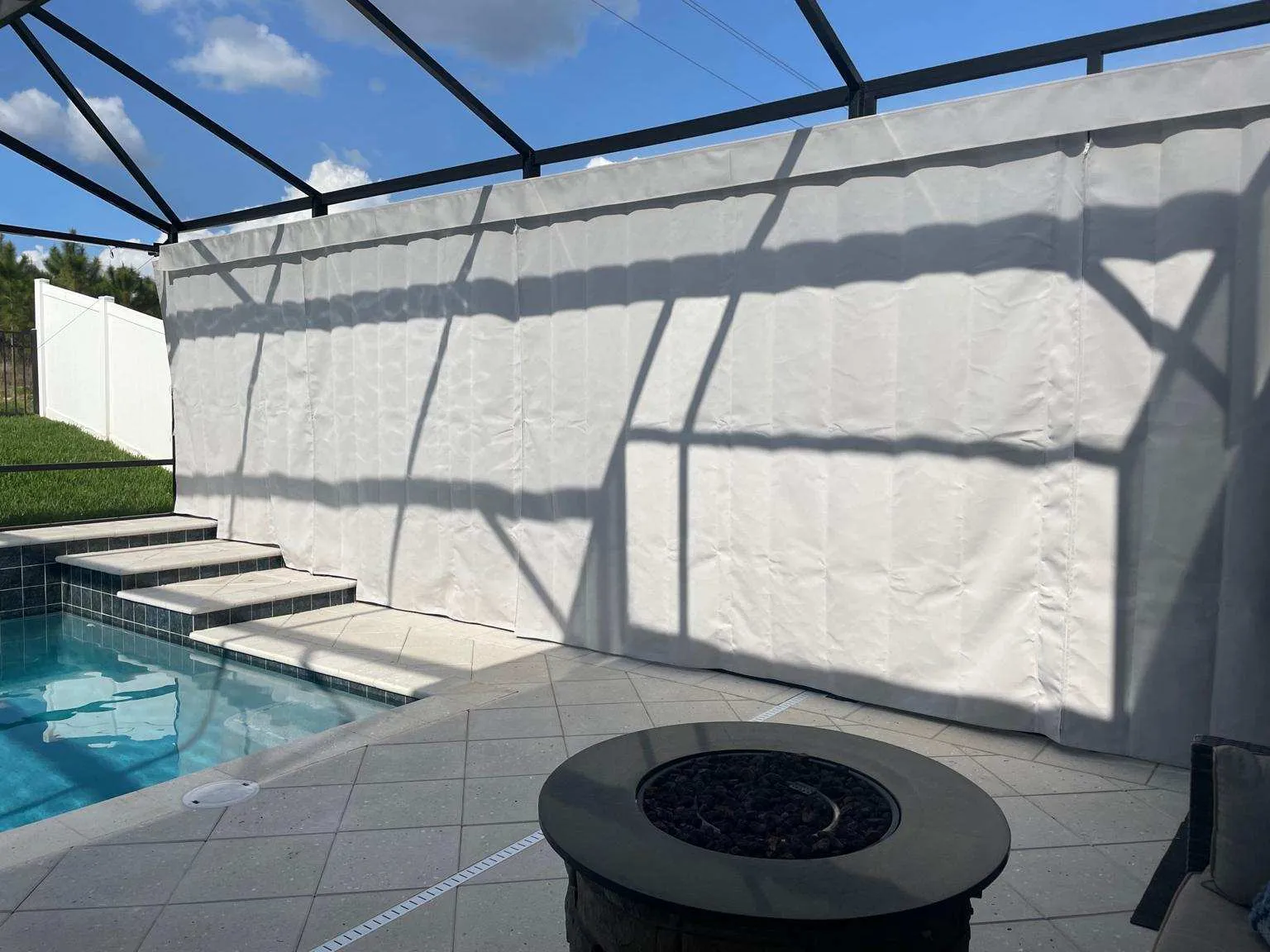 Striped lanai curtains providing seclusion on Naples golf course property